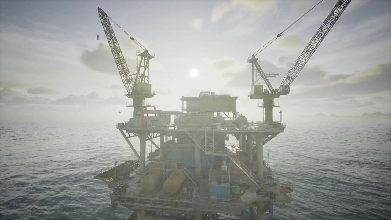 Sunrise illuminates offshore oil rig with serene sea background