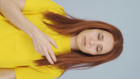 Vertical-video-of-The-woman-who-doesn't-like-her-hair.-Depressed-and-unhappy.