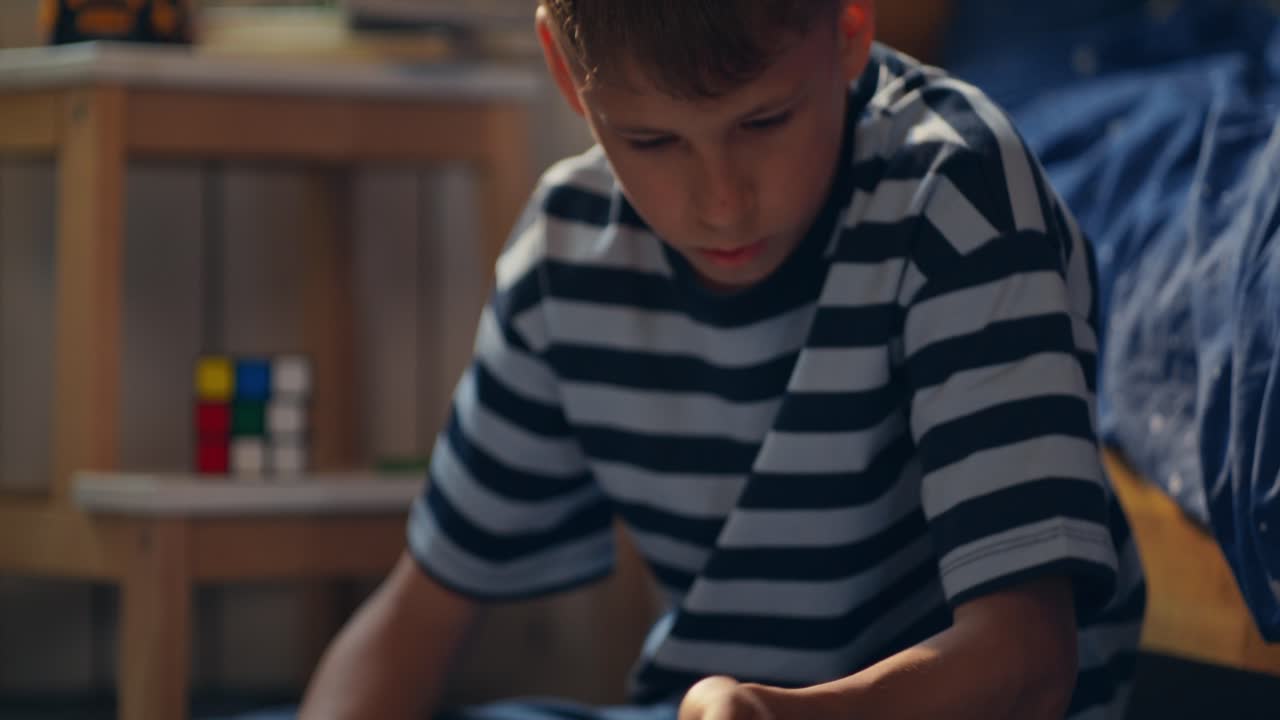 Child using a tablet for homework in their bedroom