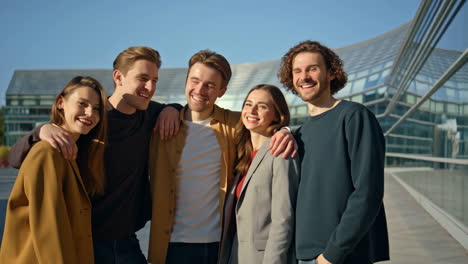 group of happy young adults smiling and socializing outdoors