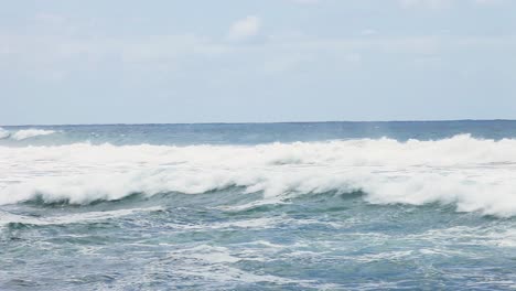 Rough-tide-waves-on-Australian-coastline-on-slightly-overcast-day-while-the-sun-has-a-chance-to-shine-through