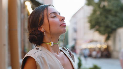 young woman taking a deep breath of fresh air, relaxing, taking a break, resting, meditating outdoor