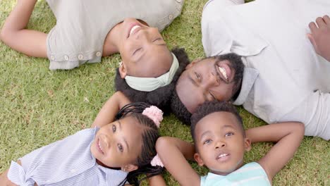 Portrait-of-happy-african-american-family-lying-in-garden,-in-slow-motion