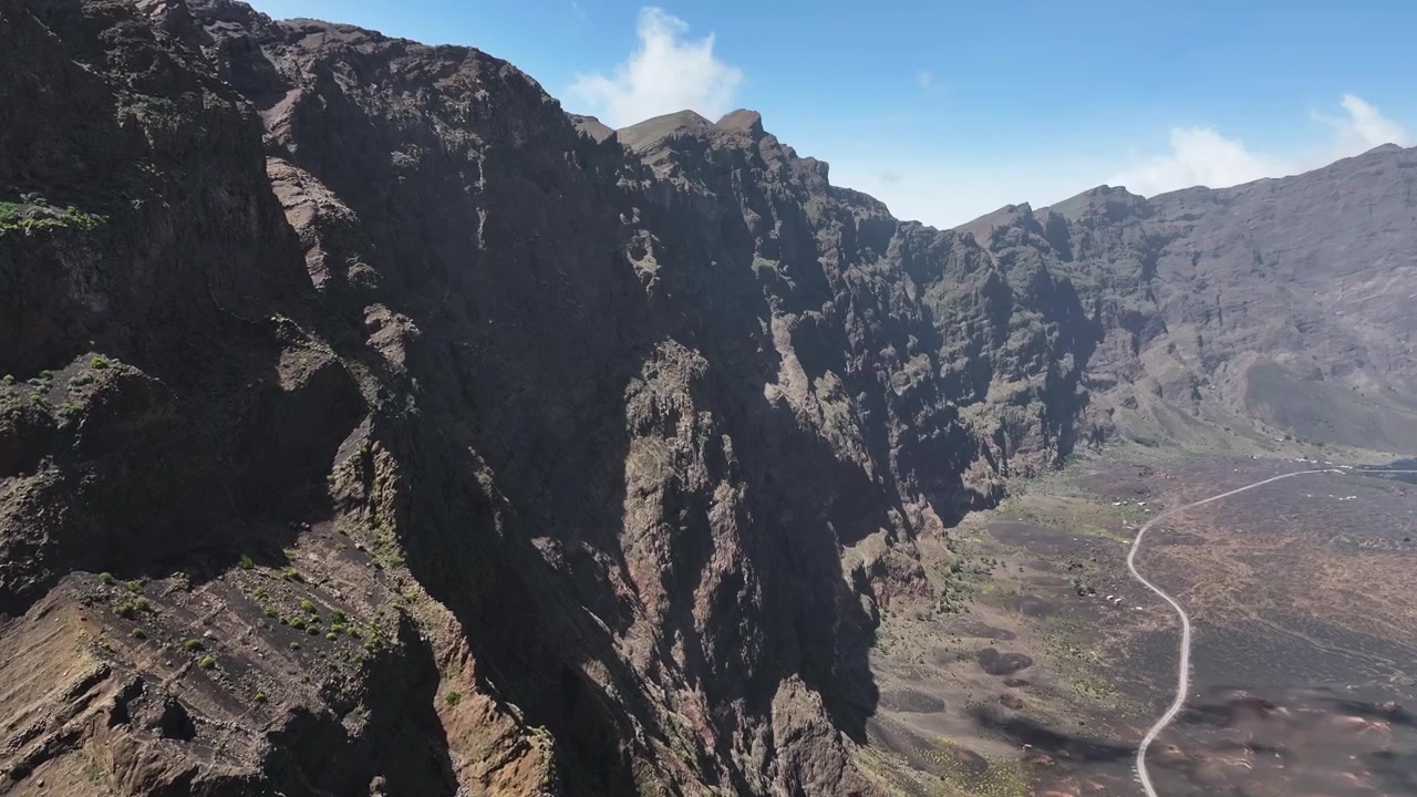 Ripresa con drone di una strada sotto una ripida catena di scogliere vulcaniche sull'isola di Fogo, Capo Verde 60fps