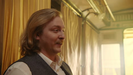 man in vintage train carriage