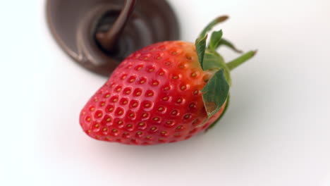 Chocolate-sauce-pouring-over-strawberry