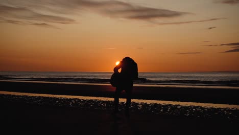 man running with guitar in back sand beach at sunset-4