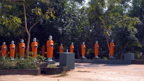 Medium-Shot-of-Monk-Offering-Statue-Bridge-in-the-Day