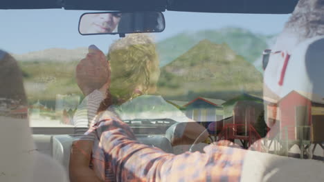 driving convertible, couple enjoying scenic mountain landscape through windshield