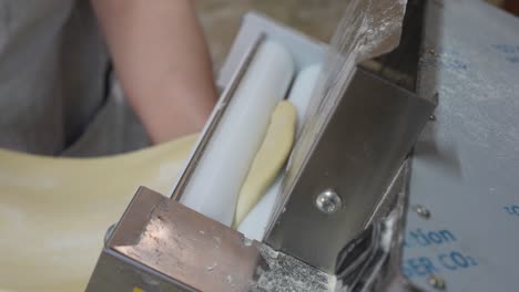 using a press to roll out pastry dough