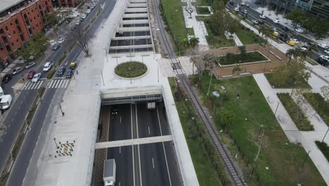 Aerial-slow-motion-shot-showing-driving-trucks-into-tunnel-under-Buenos-Aires-City,Argentina