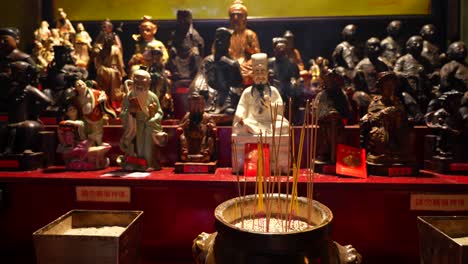 incense burner and buddhist sculptures in tin hau temple, hong kong