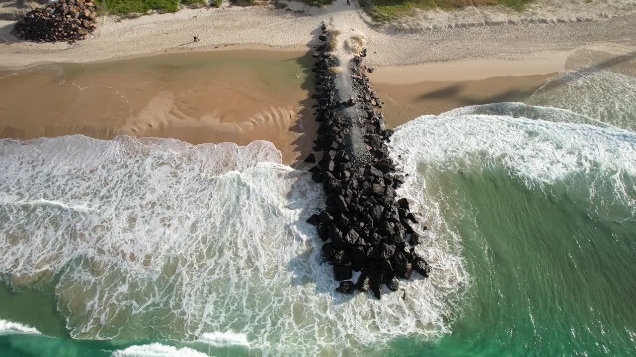 Waves Breaking On Jetty Rocks In Palm Beach, Queensland, Australia - Drone Shot
