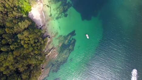 Aerial-top-down-over-pristine-beach-around-crystal-clear-blue-waters-of-Galicia,-Spain