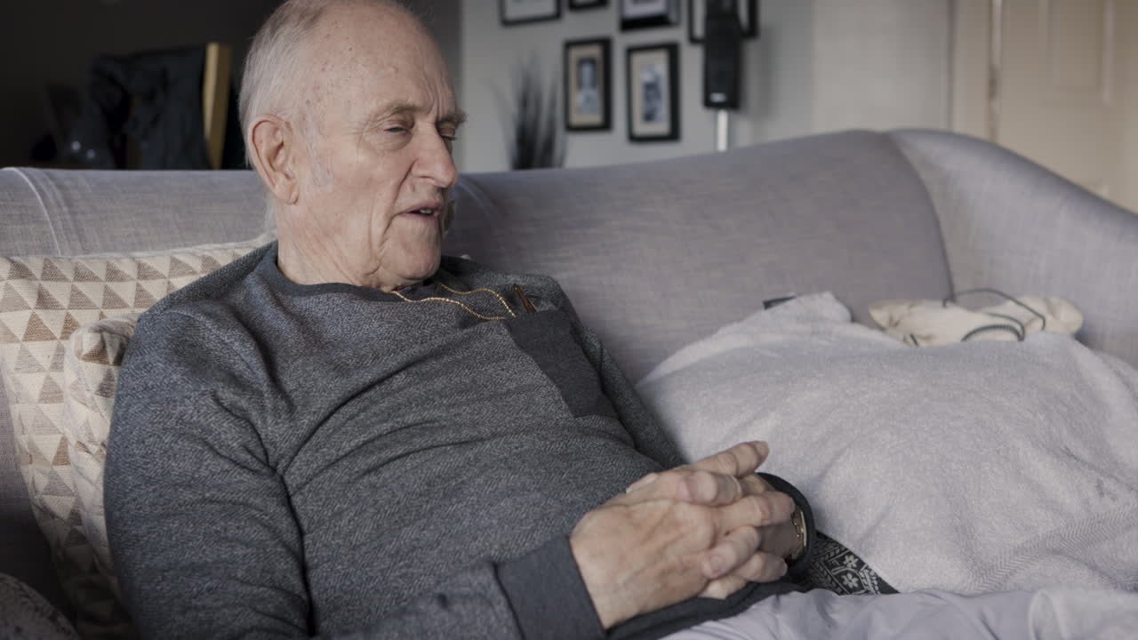 Elderly man sitting on a couch