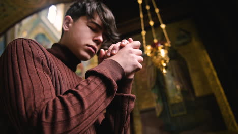 man praying indoors