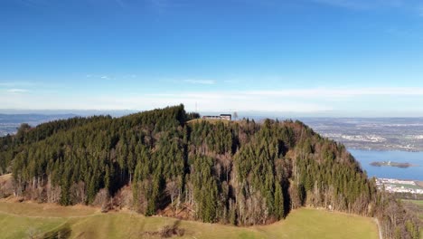 aerial view of mountain etzel covered with trees and lake zurich in background