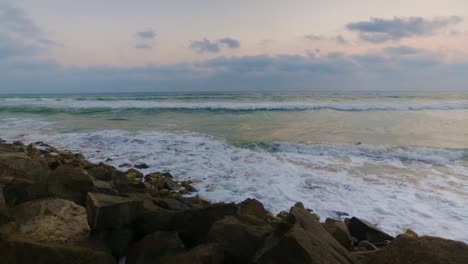 olas y espuma en la playa rocosa