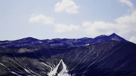 mountains with unique lines and textures under a clear blue sky