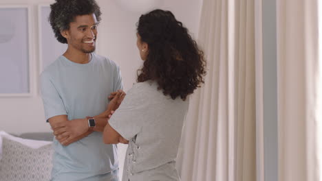 happy young couple dancing at home enjoying funny dance having fun celebrating