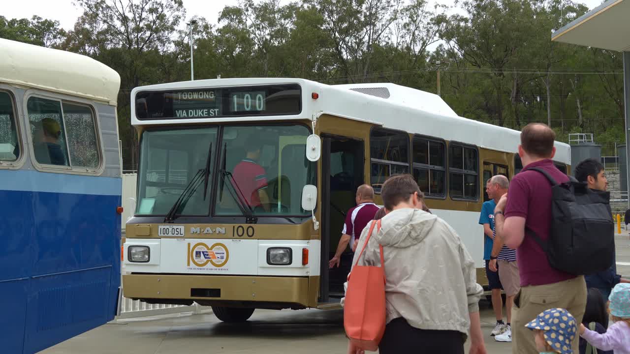 Close up shot capturing visitors visiting the Brisbane Metro Depot at Rochedale during Community Open Day with vintage bus exhibiting on site.