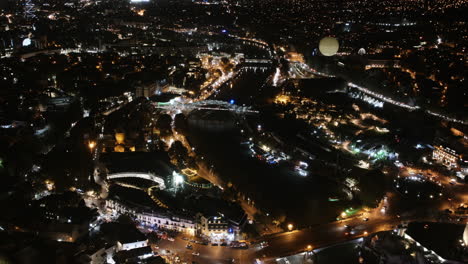 aerial timelapse of downtown tbilisi, georgia at night with traffic and hot air balloon and lights
