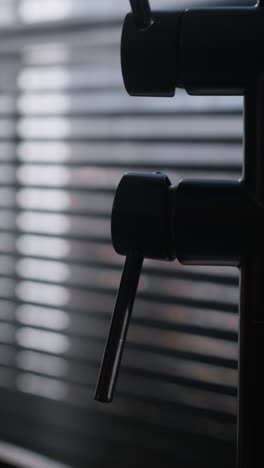 close-up of a black faucet handle