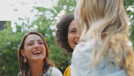 Tres-Amigas-Sentadas-Al-Aire-Libre-En-El-Jardín-De-Verano-En-Casa-Relajándose-Y-Hablando