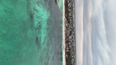 Vertical-View-Crystal-Clear-Waters-Of-Nungwi-Beach-Summer-Travel-In-Zanzibar,-Africa,-Tanzania