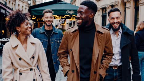 a lively group walks down a european street, captured from a low-angle, creating a dynamic