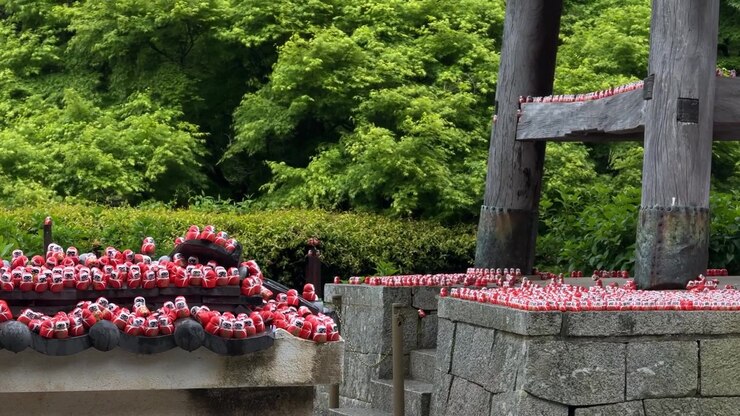 Red Daruma lucky dolls left as offerings at the historic Katsuo-ji Temple Osaka, Japan