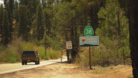 View-of-a-black-SUV-heading-towards-scenic-Pleasant-Valley,-California,USA-with-a-speed-limit-of-35-KPH-on-a-bright-sunny-day