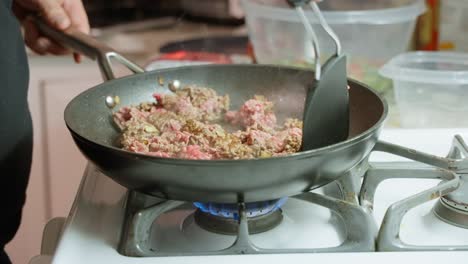 mince beef browning and stirred with black spatula caucasian home chef