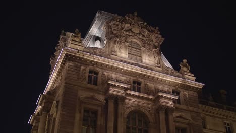 historic building facade musée du louvre. glide shot. paris tourism attraction famous landmark. romantic honeymoon travel destination. glide shot in 4k. close up view of louvre building at night time.