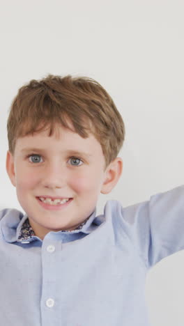 video of happy caucasian boy standing at school and gesturing