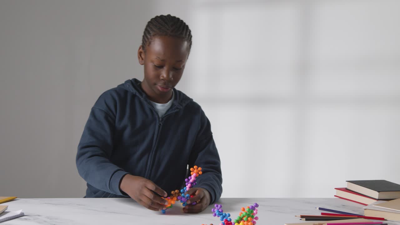 Boy On ASD Spectrum Playing With Shape Puzzle On White Background 