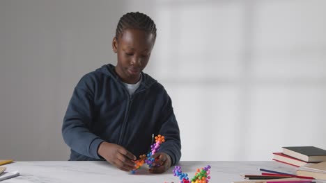 boy on asd spectrum playing with shape puzzle on white background