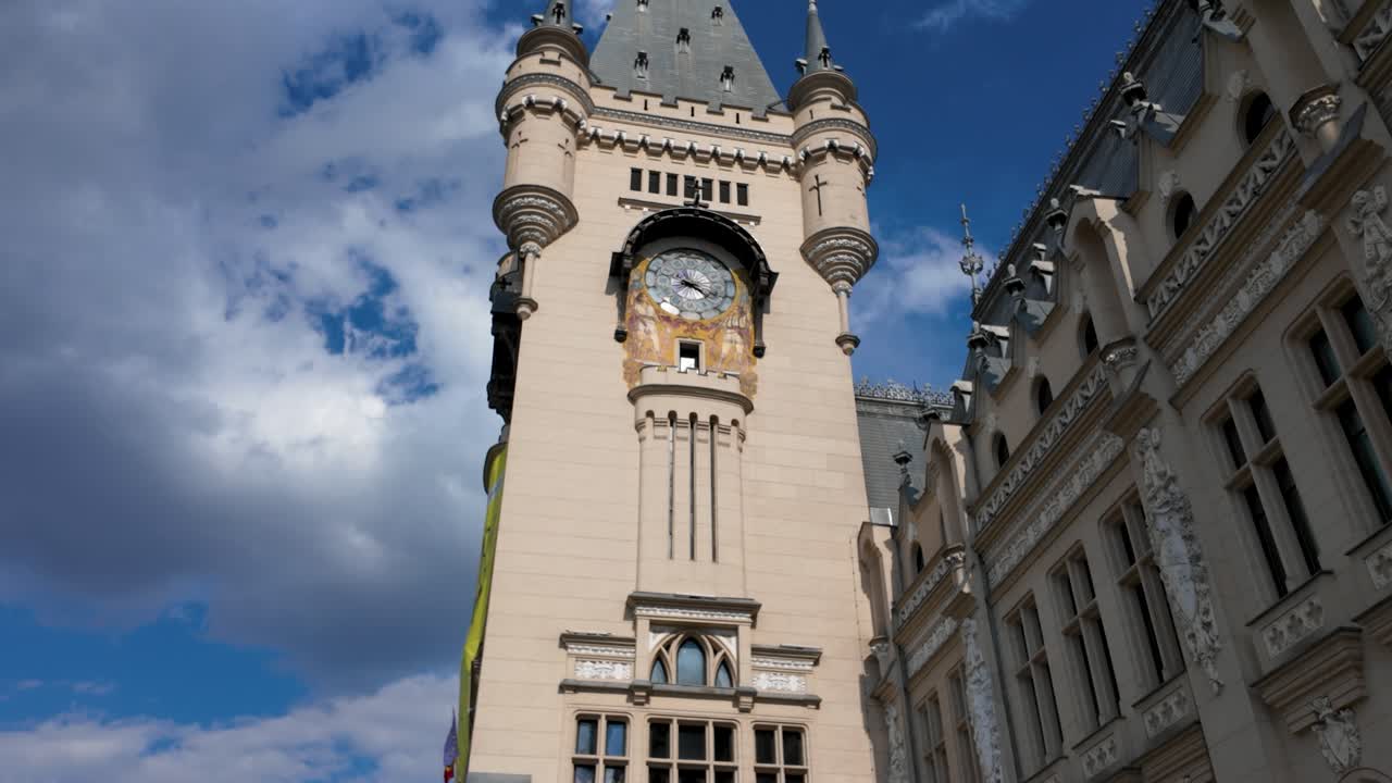 Hyperlapse of Palace of Culture full clock tower facade in Iasi Romania with moving clouds and detailed historic architecture