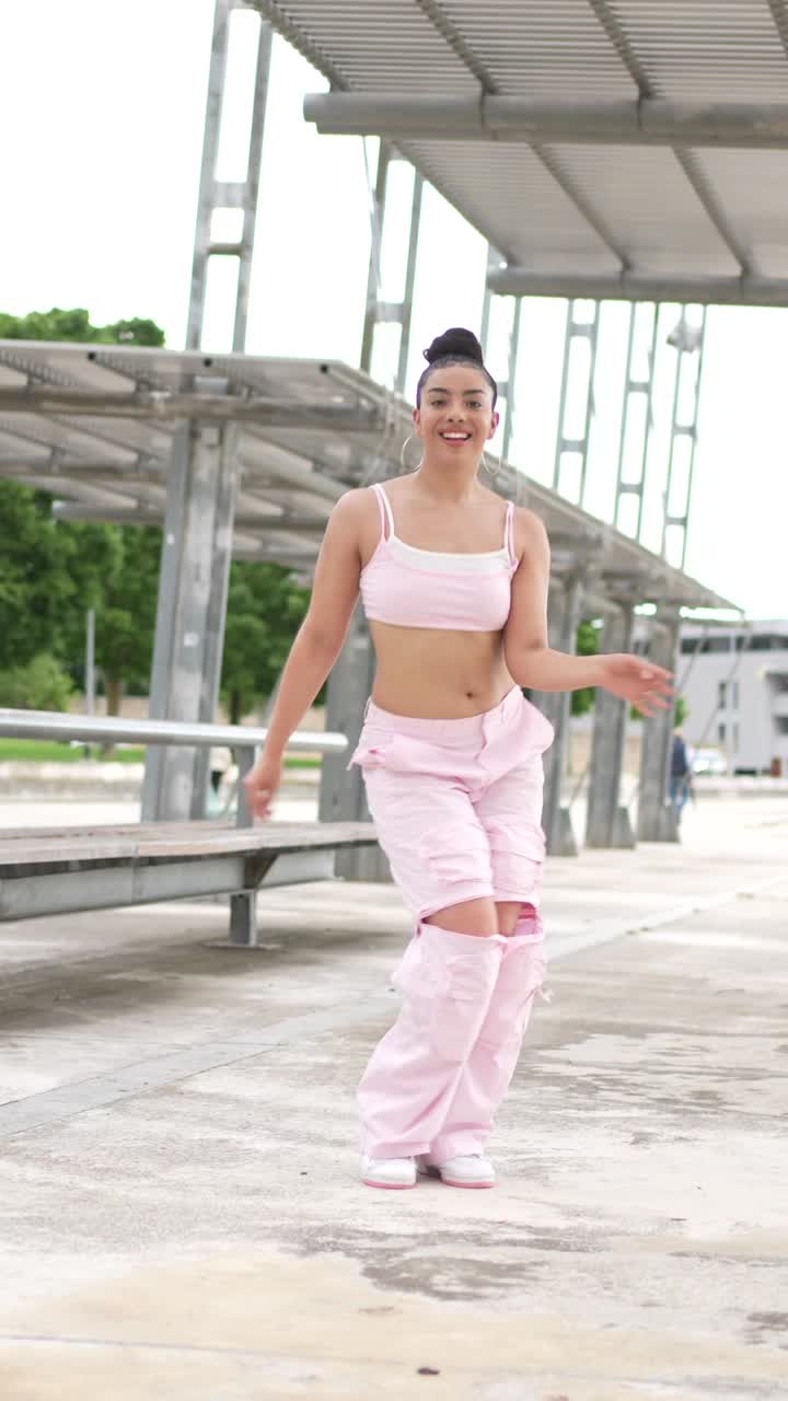 Woman Dancing in Pink Outfit Outdoors