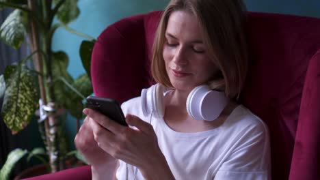 charming girl starting listen to music in headphones