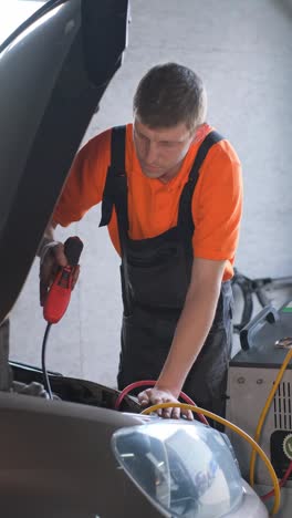 a mechanic working on a car engine in a garage