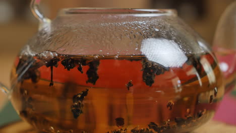 glass teapot with tea leaves