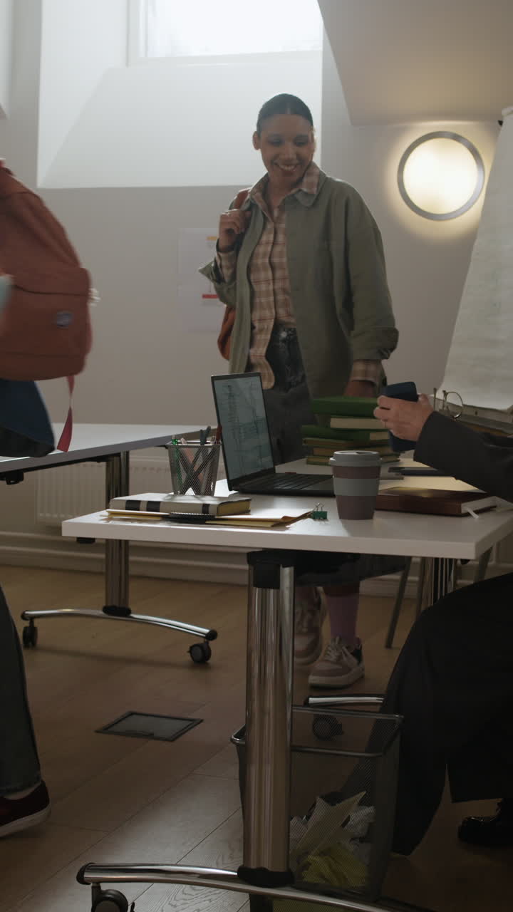 Classroom meeting with students and a laptop presentation