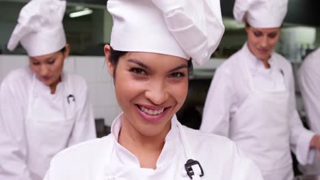 smiling chef whisking eggs in a bowl