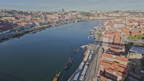 porto city and the douro river from luis i bridge with buildings and tunnel below, aerial view