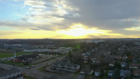 Drone-descends-over-suburban-Kitchener,-Ontario-homes-at-sunset