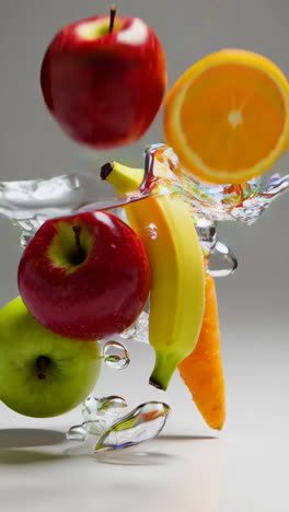 fresh fruits splashing in water