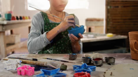 girl painting a bowl