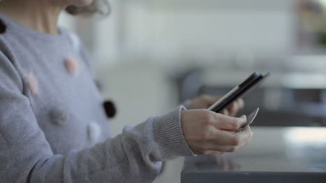 cropped shot of woman holding credit card and tablet.