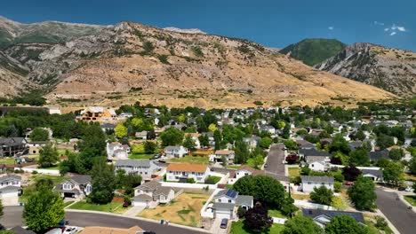 Descending Aerial Shot Of Mountains Behind A Suburban Neighborhood In Pleasant Grove, Utah